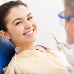 Image of smiling patient looking at camera at the dentists