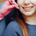 Girl talking to the dendist. Beautiful lady in the dentist's office. Woman in a uniform